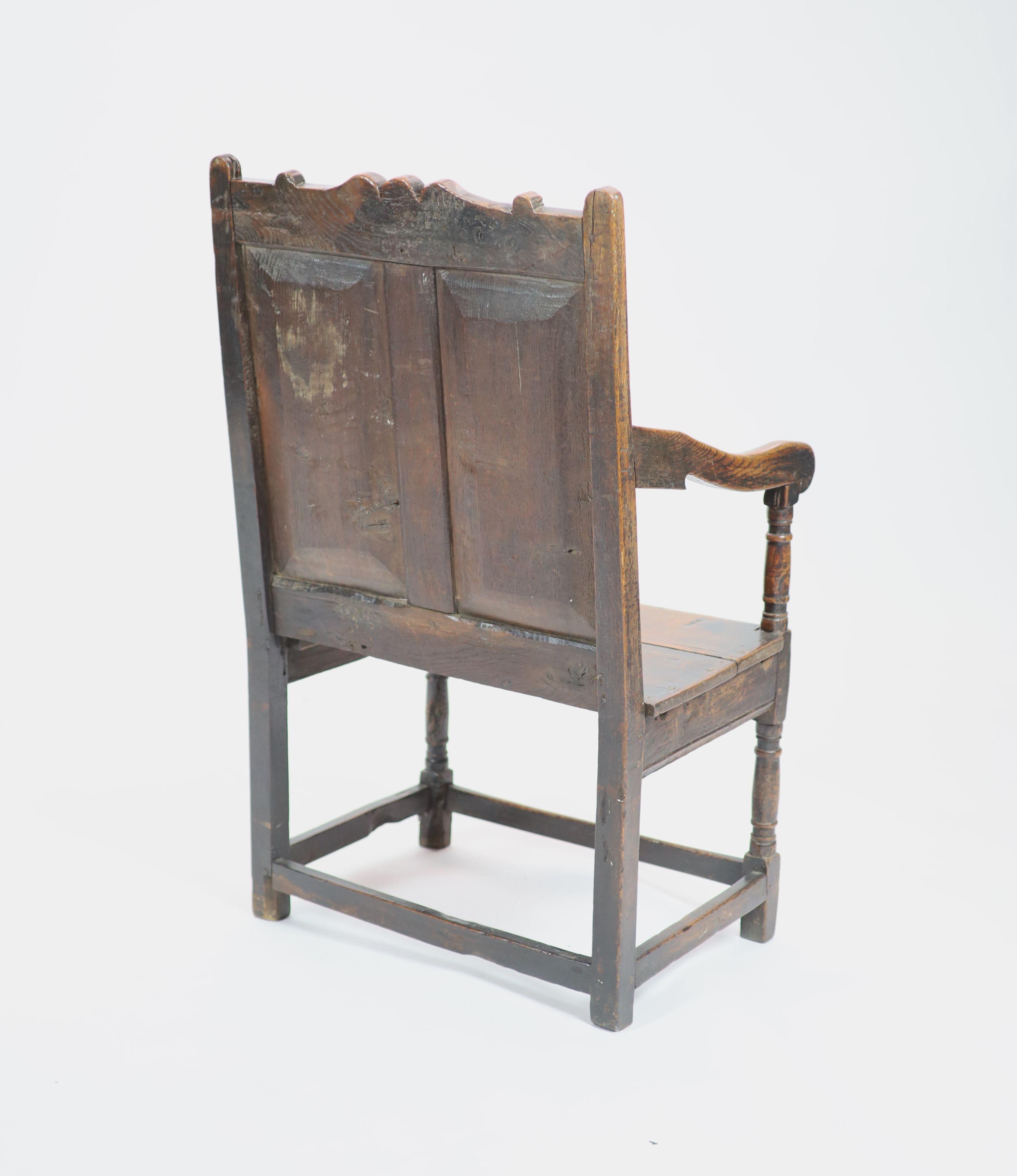 A 17th century oak open armchair, H 103cm. W 60cm. D 54cm.
